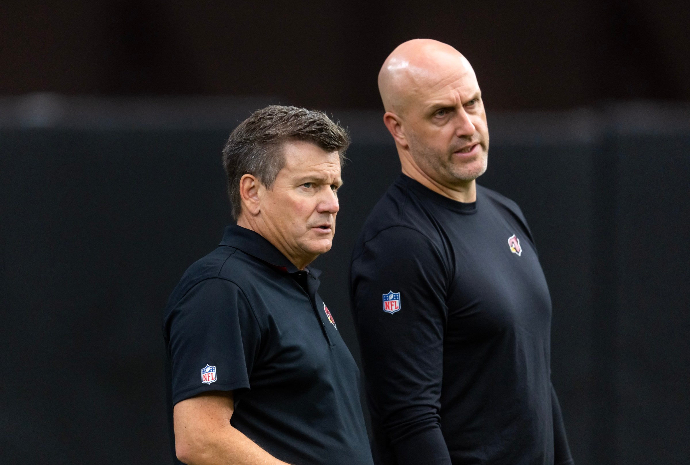 Aug 2, 2025; Glendale, AZ, USA; Arizona Cardinals owner Michael Bidwill (left) with general manager Monti Ossenfort at the Red and White practice during training camp at State Farm Stadium. Mandatory Credit: Mark J. Rebilas-Imagn Images
