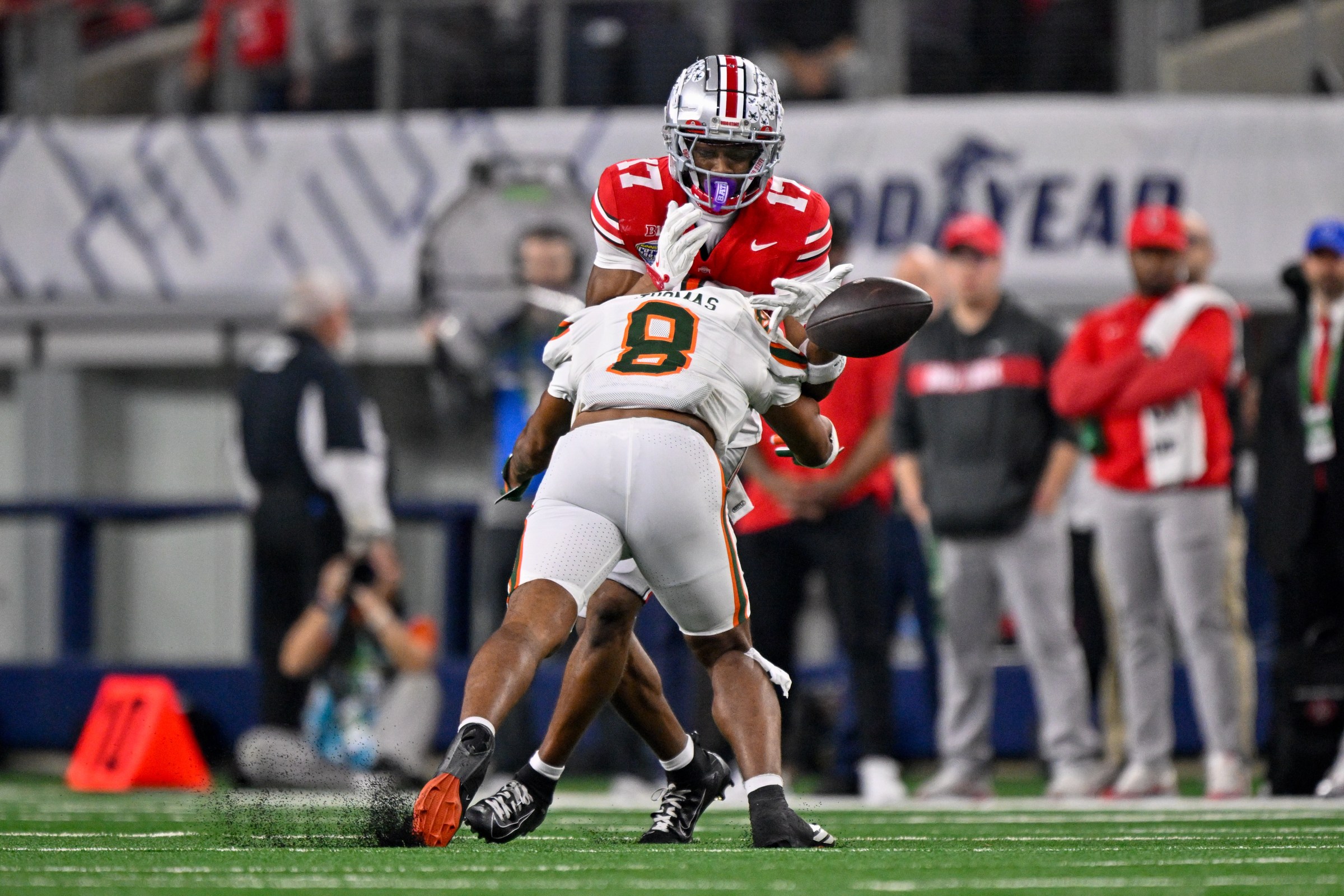 Dec 31, 2025; Arlington, TX, USA; Miami Hurricanes defensive back Jakobe Thomas (8) knocks the ball away from Ohio State Buckeyes wide receiver Carnell Tate (17) during the 2025 Cotton Bowl and quarterfinal game of the College Football Playoff at AT&T Stadium. Mandatory Credit: Jerome Miron-Imagn Images