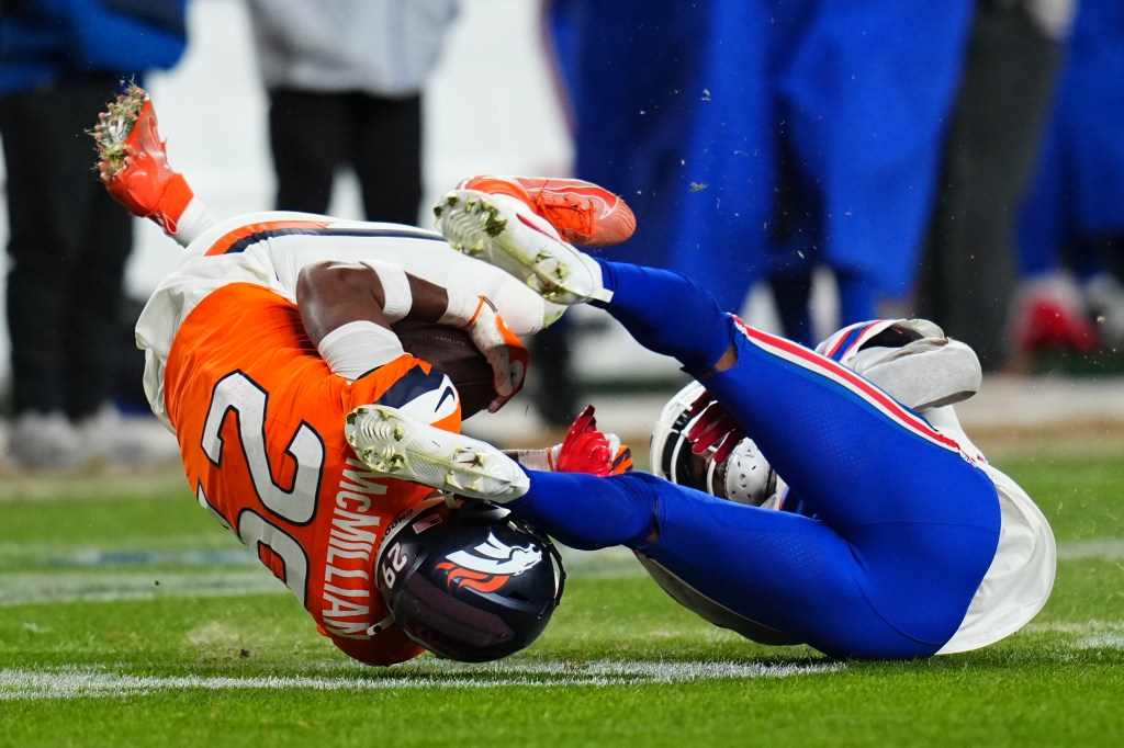 Broncos cornerback Ja'quan McMillian (29) intercepts a pass intended for Buffalo Bills wide receiver Brandin Cooks (18) during overtime of an NFL divisional round playoff football game, Saturday, Jan. 17, 2026, in Denver.