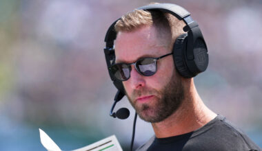 Washington Commanders OC Kliff Kingsbury looks at his play sheet....