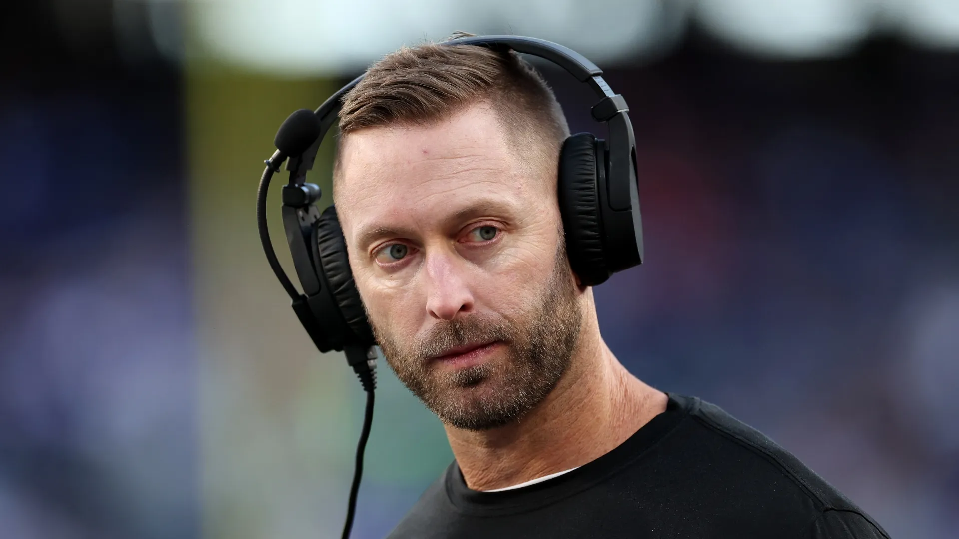 Kliff Kingsbury with headset during a game