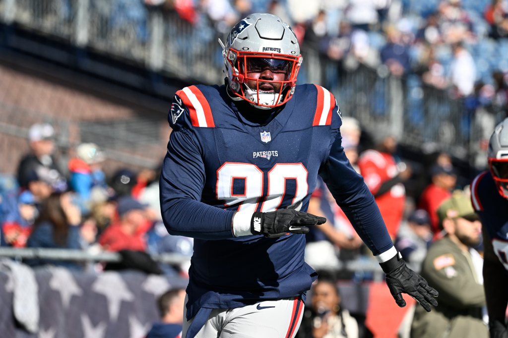 New England Patriots defensive tackle Christian Barmore (90) warms up.