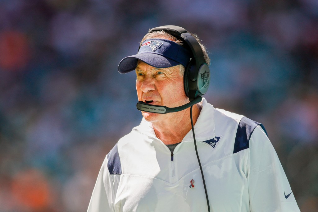 New England Patriots head coach Bill Belichick watching from the sideline.