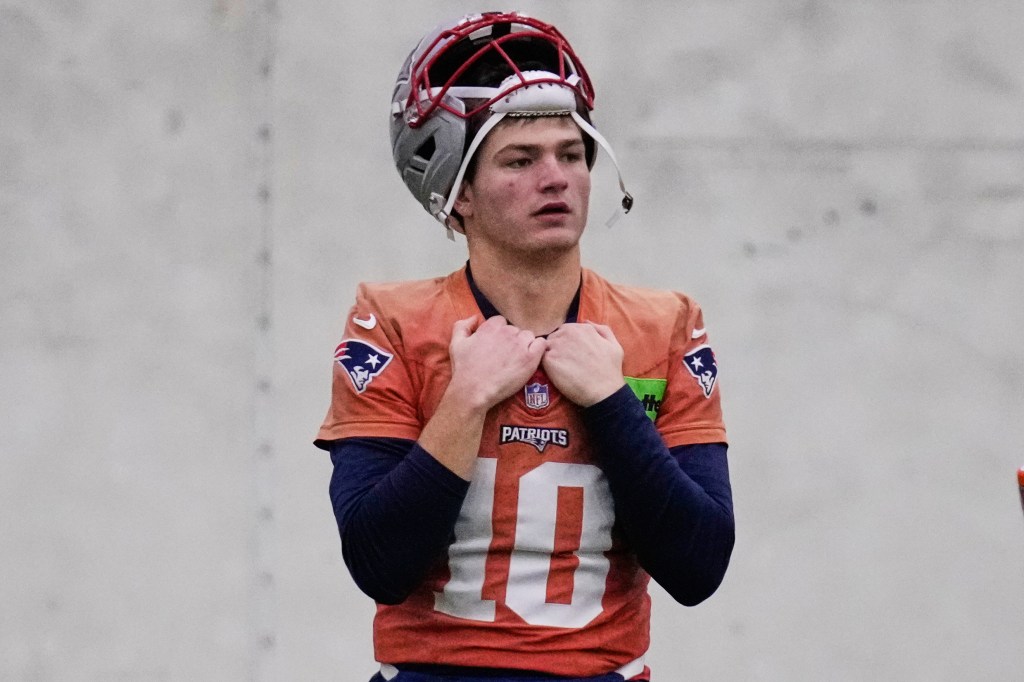 New England Patriots quarterback Drake Maye in uniform with his helmet on his head.