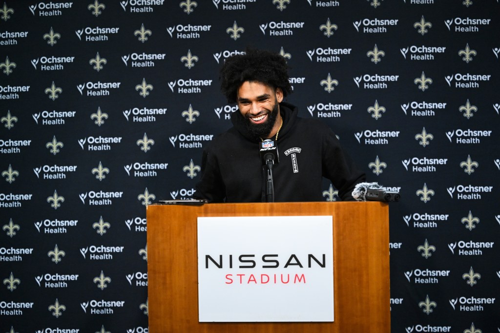New Orleans Saints wide receiver Chris Olave talks to reporters after an NFL football game.