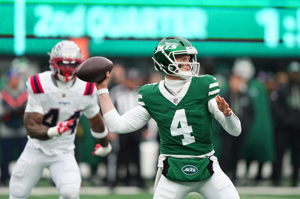 New York Jets quarterback Brady Cook (4) throws a pass against New England Patriots linebacker K'Lavon Chaisson (44).