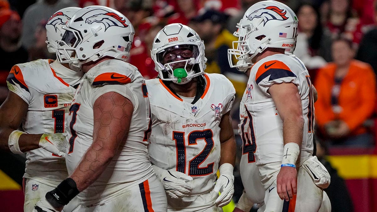 Broncos players celebrate a score