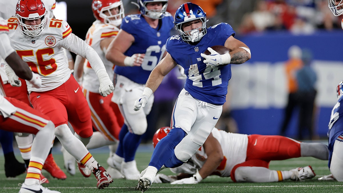 Cam Skattebo runs the ball