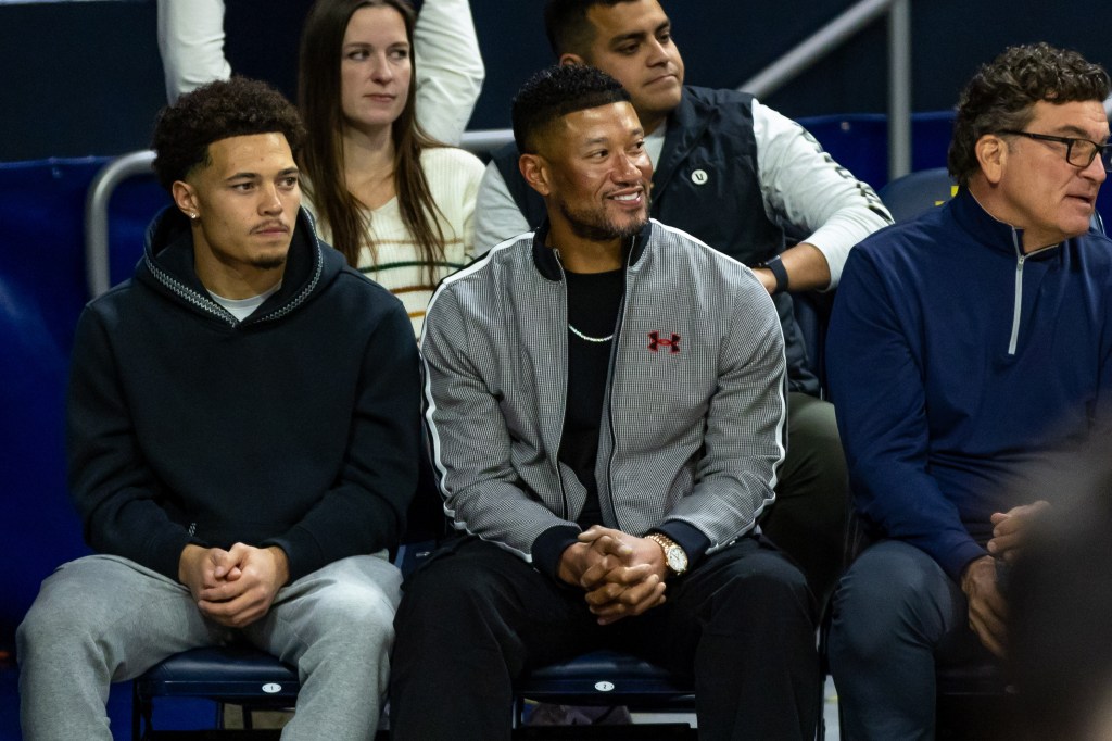 Notre Dame Fighting Irish head football coach Marcus Freeman (R) and his son, Vinny, in attendance of the men's basketball game against the Miami (FL) Hurricanes at Purcell Pavilion at the Joyce Center on January 13, 2026. 