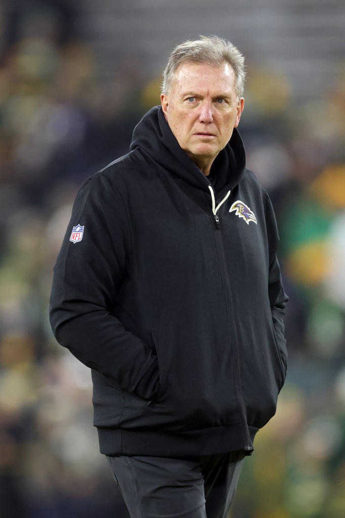 Todd Monken, offensive coordinator for the Baltimore Ravens, wears a black jacket with the Ravens logo on the chest and the NFL logo on the sleeve.