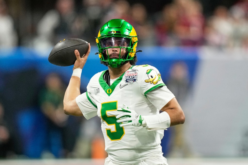 Oregon quarterback Dante Moore (5) passes against Indiana during the second half of the Peach Bowl on Jan. 9, 2026.