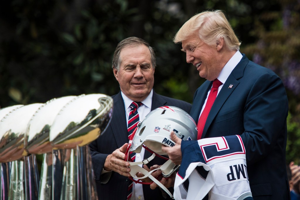 President Donald Trump is presented with a New England Patriots helmet and jersey by head coach Bill Belichick.