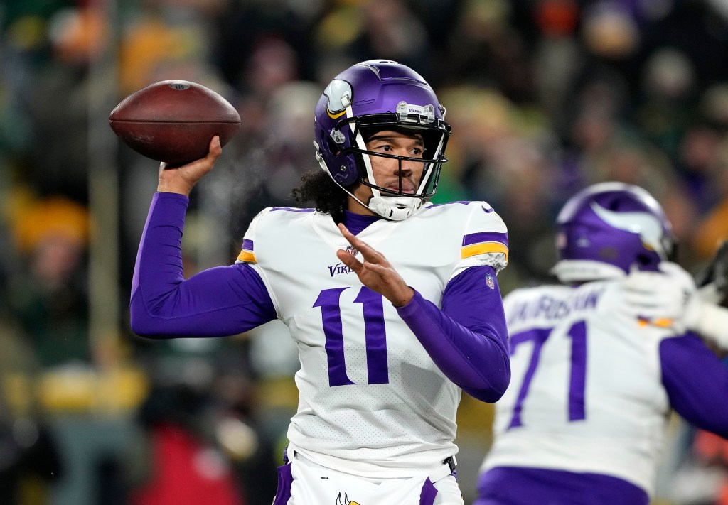 Minnesota Vikings quarterback Kellen Mond #11 prepares to throw the football during a game against the Green Bay Packers.