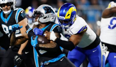 Carolina Panthers running back Rico Dowdle (5) is tackled by Los Angeles Rams linebacker Jared Verse during the first half of an NFL wild-card playoff football game, Saturday, Jan. 10, 2026, in Charlotte, N.C. (AP Photo/Rusty Jones)