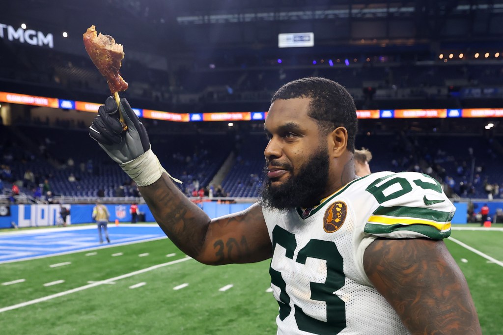 Rasheed Walker of the Green Bay Packers holds up a turkey leg after a win.
