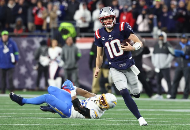 New England Patriots' Drake Maye scrambles during the second quarter of the win over the Chargers at Gillette Stadium. (Nancy Lane/Boston Herald)