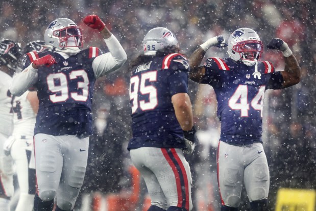 New England Patriots defensive linemen  Leonard Taylor III, Khyiris Tonga and K'Lavon Chaisson celebrate sacking Houston Texans quarterback C.J. Stroud during the fourth quarter of the divisional-round game at Gillette Stadium. (Nancy Lane/Boston Herald)