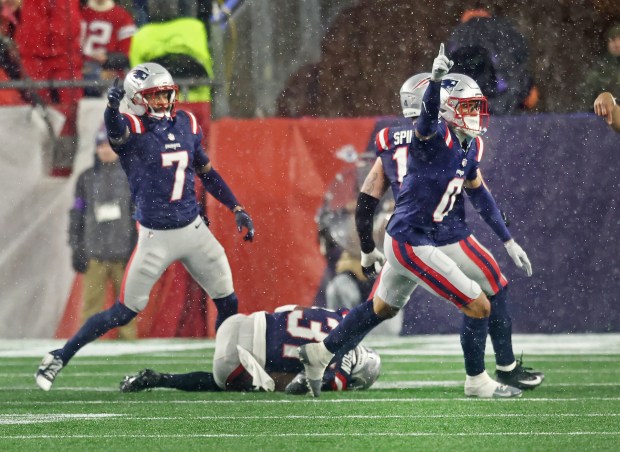 Foxboro, MA - New England Patriots' Carlton Davis III and Christian Gonzalez react asCraig Woodson recovers a fumble during the third quarter of the Divisional Round game at Gillette Stadium. (Nancy Lane/Boston Herald)