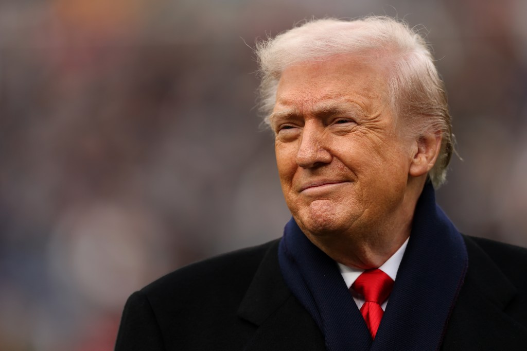 President Donald Trump smiling from the field at the 126th Army-Navy Game.