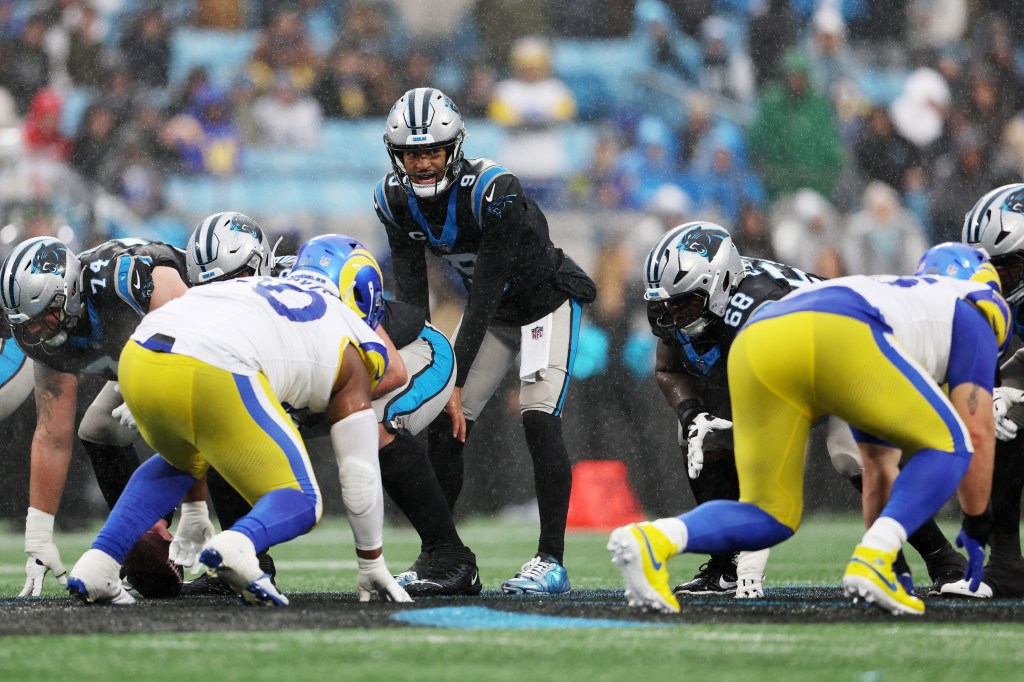 Football players from the Los Angeles Rams and Carolina Panthers lined up at the line of scrimmage.