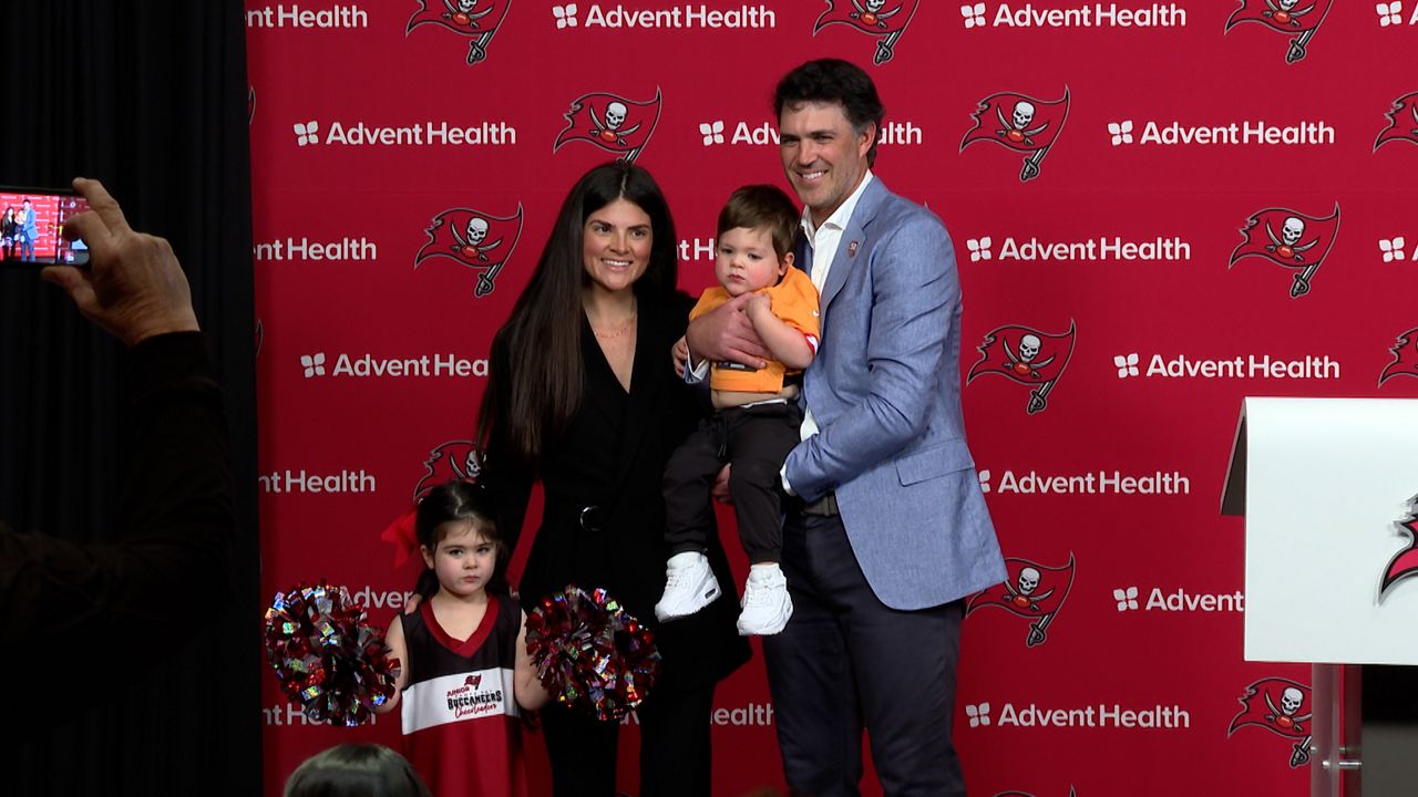Zac Robinson joins his family at the podium as he is introduced as the Tampa Bay Buccaneers new offensive coordinator. (Michael Epps - Spectrum Sports 360)