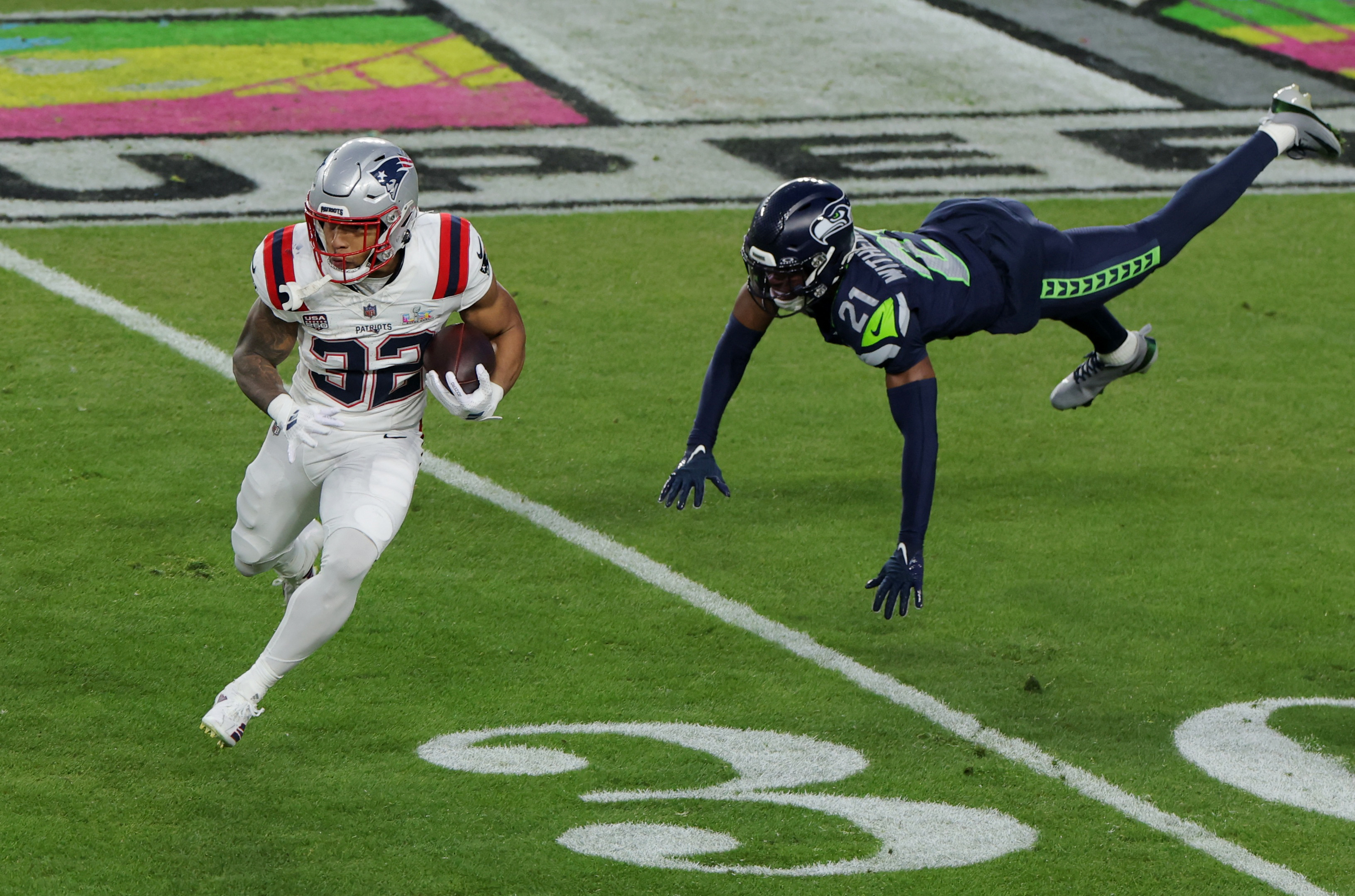 TreVeyon Henderson in action with Seattle Seahawks’ Devon Witherspoon