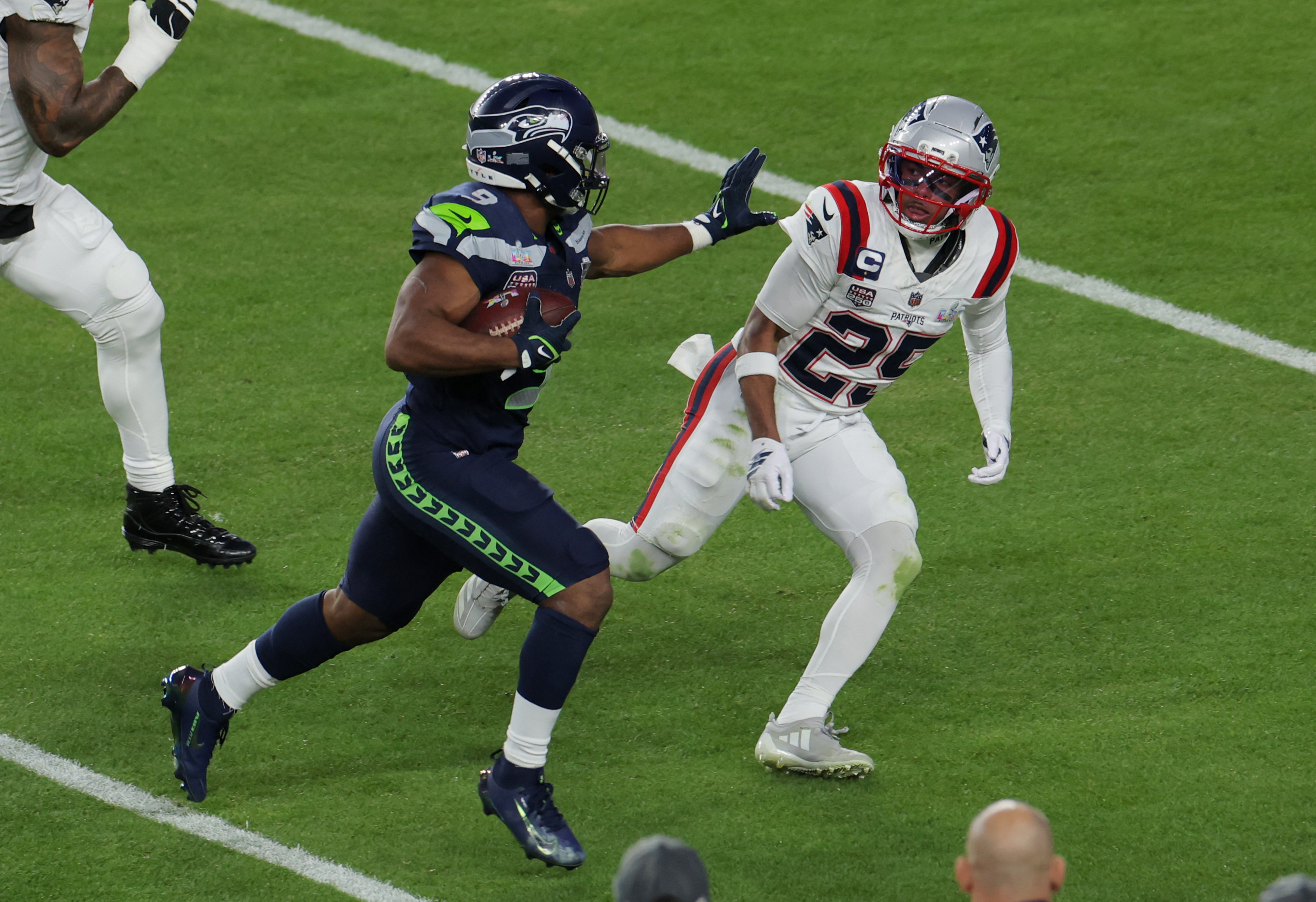 Seattle Seahawks’ Kenneth Walker in action with New England Patriots’ Marcus Jones