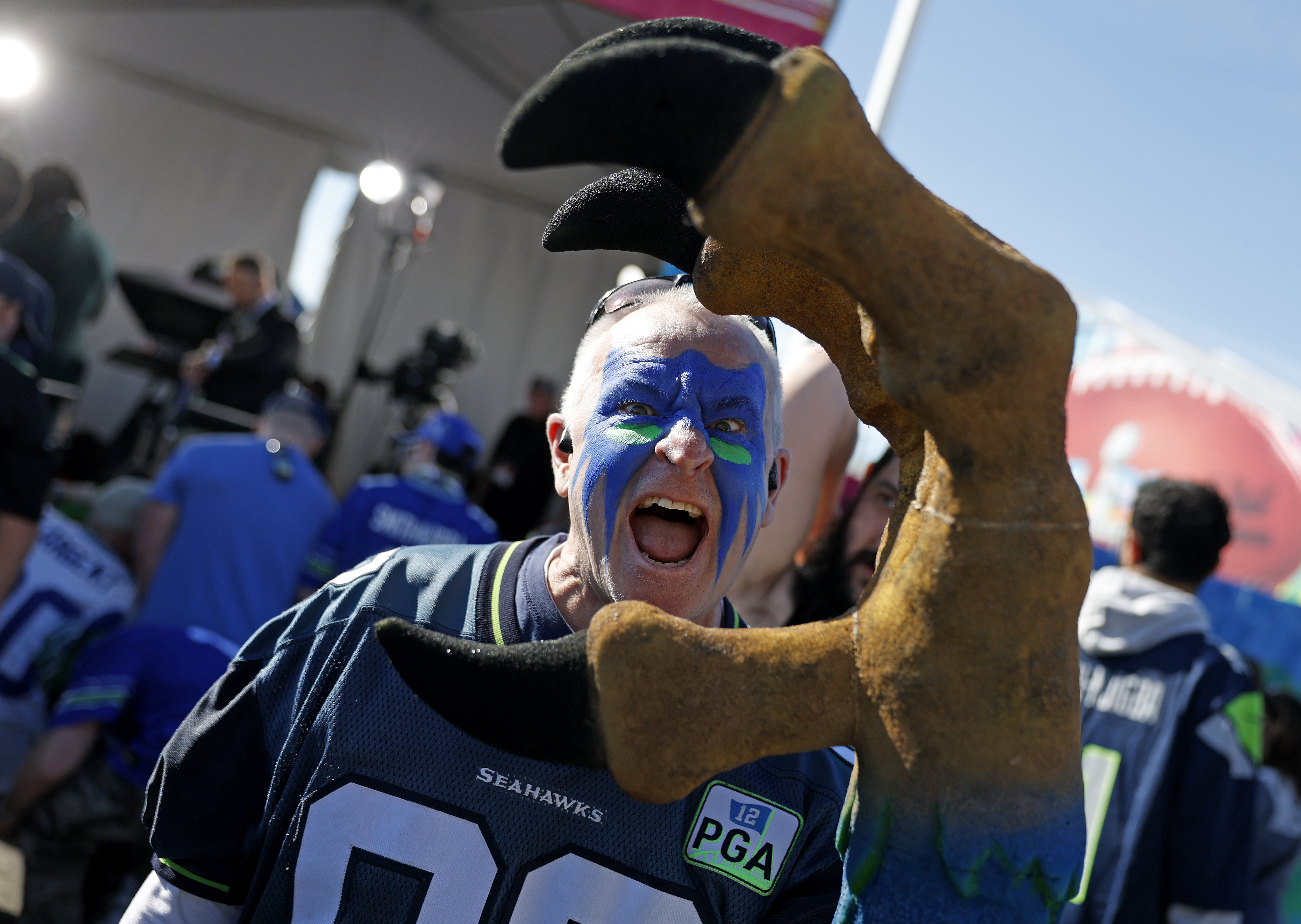A Seahawks fan holds a giant claw outside the stadium