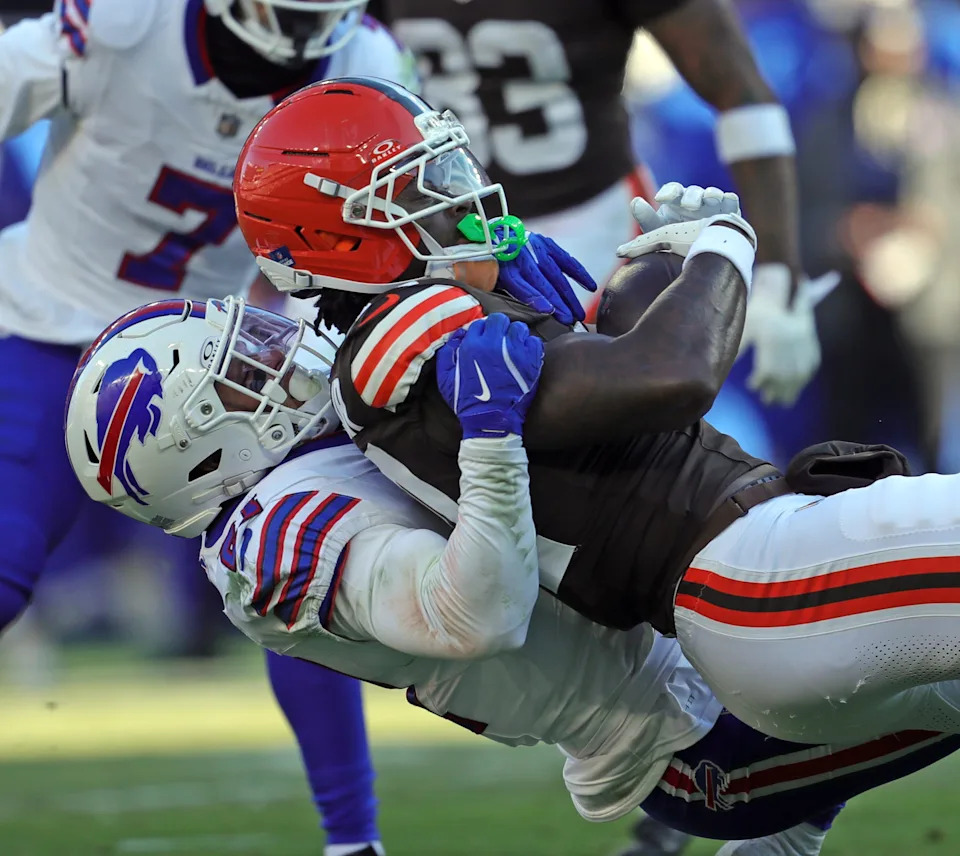 Cleveland Browns tight end Harold Fannin Jr. (44) is broght down after a catch by Buffalo Bills safety Jordan Poyer (21) during the second half of an NFL football game at Huntington Bank Field, Dec. 21, 2025, in Cleveland, Ohio.