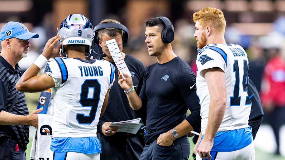 Carolina Panthers head coach Dave Canales talks to quarterbacks Bryce Young and Andy Dalton against the New Orleans Saints