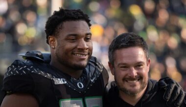 Oregon’s Isaiah World, left, takes a picture with coach Dan Lanning