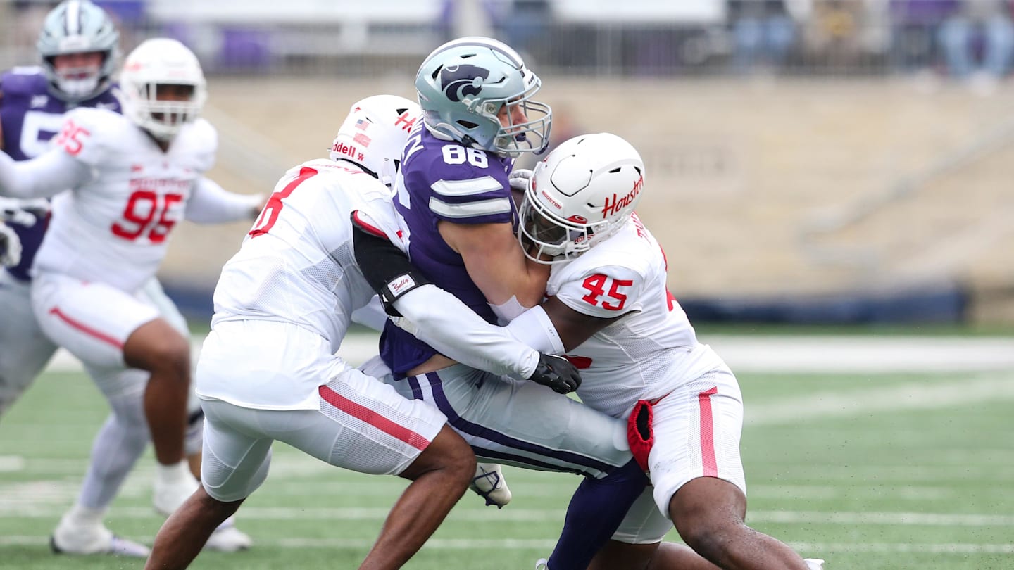 Oct 28, 2023; Manhattan, Kansas, USA; Kansas State Wildcats tight end Garrett Oakley (86) is tackled by Houston Cougars defensive lineman Nadame Tucker (45) and linebacker Malik Robinson (8) during the second quarter at Bill Snyder Family Football Stadium. Mandatory Credit: Scott Sewell-Imagn Images