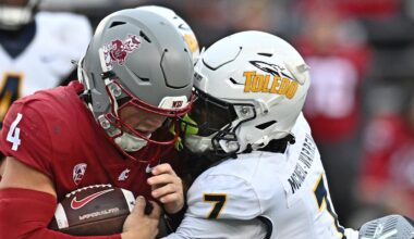 Oct 25, 2025; Pullman, Washington, USA; Washington State Cougars quarterback Zevi Eckhaus (4) is tackled by Toledo Rockets safety Emmanuel McNeil-Warren (7) in the second half at Gesa Field at Martin Stadium. Mandatory Credit: James Snook-Imagn Images