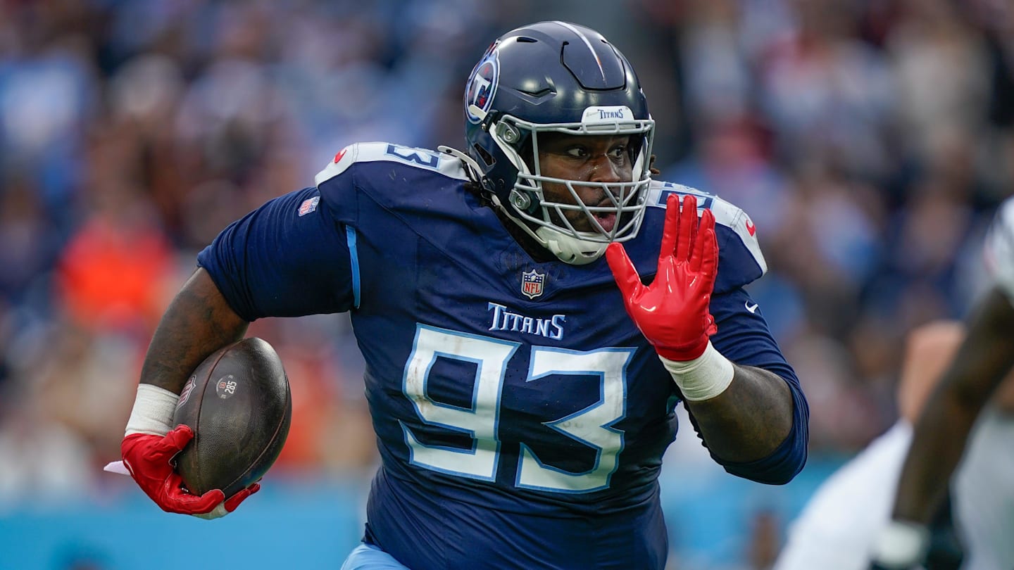 Tennessee Titans defensive tackle T'Vondre Sweat (93) returns the ball after stripping it from Cincinnati Bengals quarterback Joe Burrow (9) during the second quarter at Nissan Stadium in Nashville, Tenn., Sunday, Dec. 15, 2024.