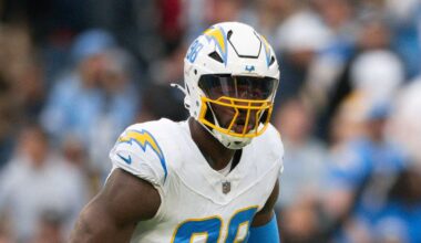 Nov 2, 2025; Nashville, Tennessee, USA;  Los Angeles Chargers linebacker Odafe Oweh (98) celebrates his sack with linebacker Tuli Tuipulotu (45) against the Tennessee Titans during the second half at Nissan Stadium. Mandatory Credit: Steve Roberts-Imagn Images