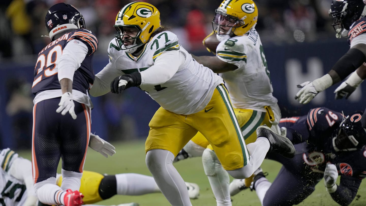 Green Bay Packers guard Jordan Morgan (77) clears the way for running back Josh Jacobs (8) during the second quarter of their wild card playoff game against the Chicago Bears Saturday, January 10, 2026 at Soldier Field in Chicago, Illinois.
