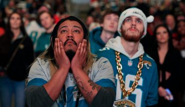 Jacksonville Jaguars fans Griffin Lasch, center, and Garrett Roberson, right, react to costly mistakes during the second half Saturday, Jan 21, 2023 at TIAA Bank Field's Dream Finders Homes Flex Field at Daily's Place in Jacksonville, Fla.
