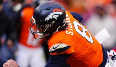 Jan 25, 2026; Denver, CO, USA; Denver Broncos quarterback Jarrett Stidham (8) rushes the ball past New England Patriots cornerback Marcus Jones (25) during the first half in the 2026 AFC Championship Game at Empower Field at Mile High. Mandatory Credit: Ron Chenoy-Imagn Images