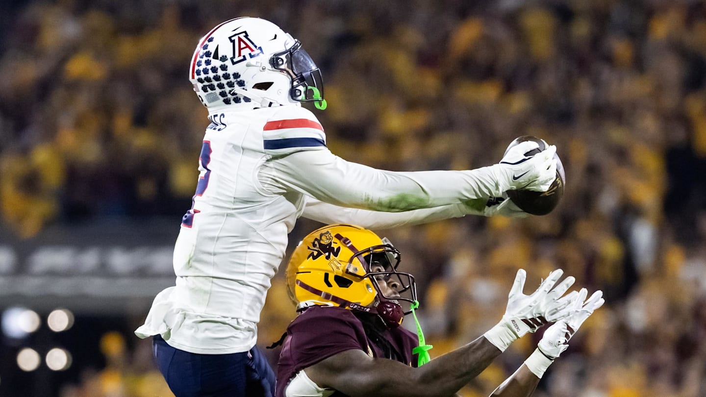 Nov 28, 2025; Tempe, Arizona, USA; Arizona Wildcats defensive back Treydan Stukes (2) intercepts the ball against Arizona State Sun Devils wide receiver Jaren Hamilton (16) in the second half during the 99th Territorial Cup at Mountain America Stadium. Mandatory Credit: Mark J. Rebilas-Imagn Images