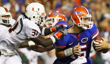 Sep 6, 2008; Gainesville, FL, USA; Florida Gators quarterback Tim Tebow (15) carries the ball as Miami Hurricanes linebacker Sean Spence (31) attempts to make the tackle in the first half at Ben Hill Griffin Stadium.  Mandatory Credit: Kim Klement-Imagn Images