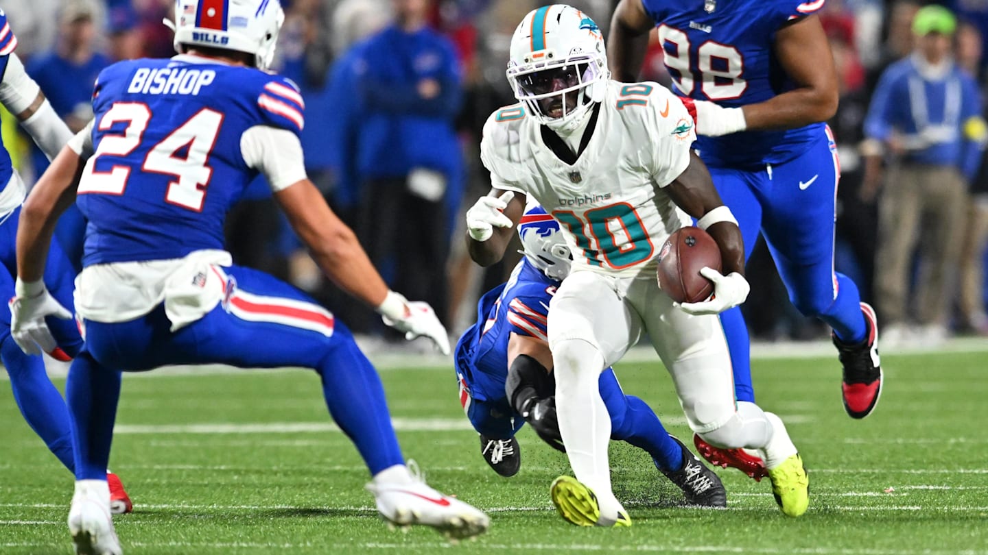 Sep 18, 2025; Orchard Park, New York, USA; Miami Dolphins wide receiver Tyreek Hill (10) runs against Buffalo Bills linebacker Terrel Bernard (8) and safety Cole Bishop (24) in the second quarter at Highmark Stadium. Mandatory Credit: Mark Konezny-Imagn Images