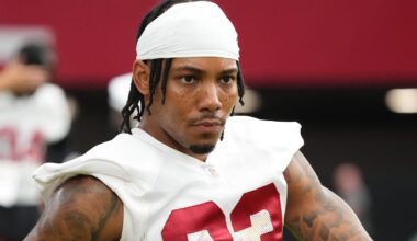 Arizona Cardinals cornerback Sean Murphy-Bunting (23) stretches out along the sidelines during the team's training camp session at State Farm Stadium in Glendale on July 24, 2024.