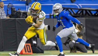 Green Bay Packers wide receiver Christian Watson (9) catches a pass against Detroit Lions cornerback Amik Robertson (21) during the third quarter at Ford Field.