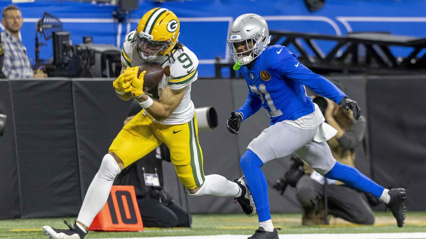 Green Bay Packers wide receiver Christian Watson (9) catches a pass against Detroit Lions cornerback Amik Robertson (21) during the third quarter at Ford Field.