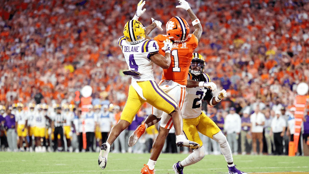T.J. Moore #1 of the Clemson Tigers attempts to get the ball against Mansoor Delane #4 and Jardin Gilbert #2 of the LSU Tigers during the first quarter at Memorial Stadium on August 30, 2025 in Clemson, South Carolina. (Photo by Katie Januck/Getty Images)