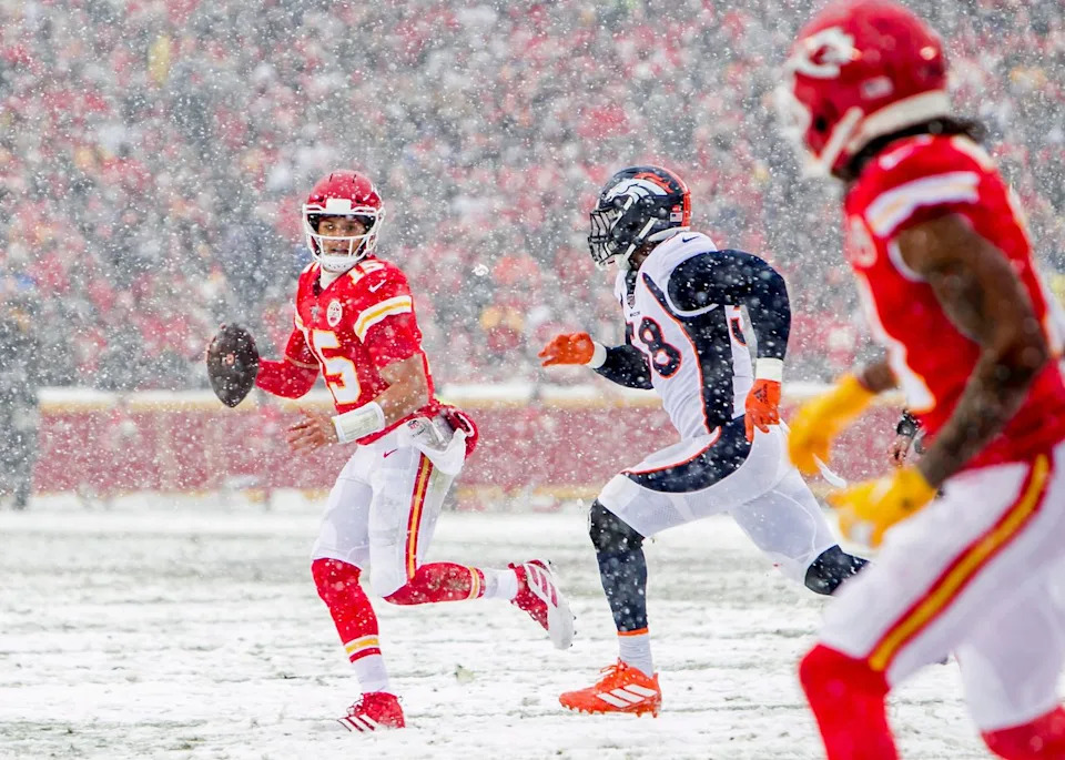 Patrick Mahomes scrambles in snow with ball during Chiefs game at Arrowhead Stadium in December 2019. Nick Tre. Smith/Icon Sportswire via Getty