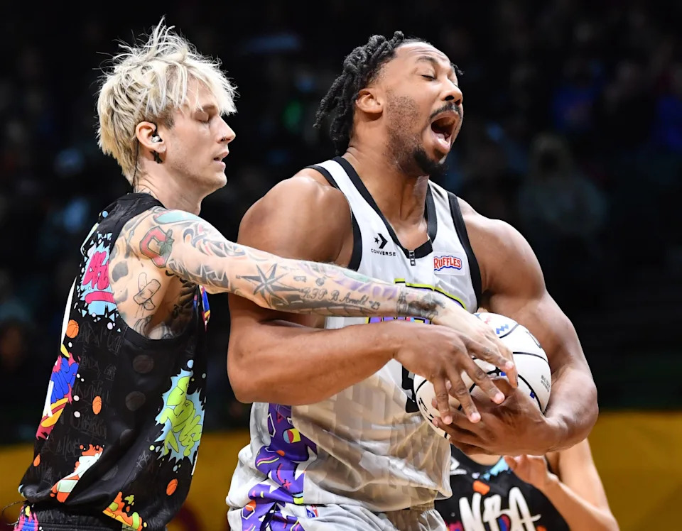 Team Walton player Machine Gun Kelly defends Team Nique player Myles Garrett of the Cleveland Browns during the NBA All-Star Celebrity Game at the Wolstein Center in February 2022 in Cleveland.
