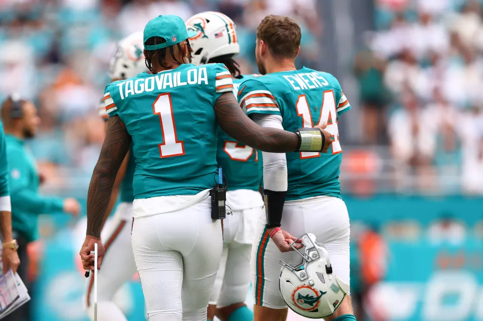 Tua Tagovailoa #1 and Quinn Ewers #14 of the Miami Dolphins embrace during the second half of the game against the Cincinnati Bengals at Hard Rock Stadium on December 21, 2025