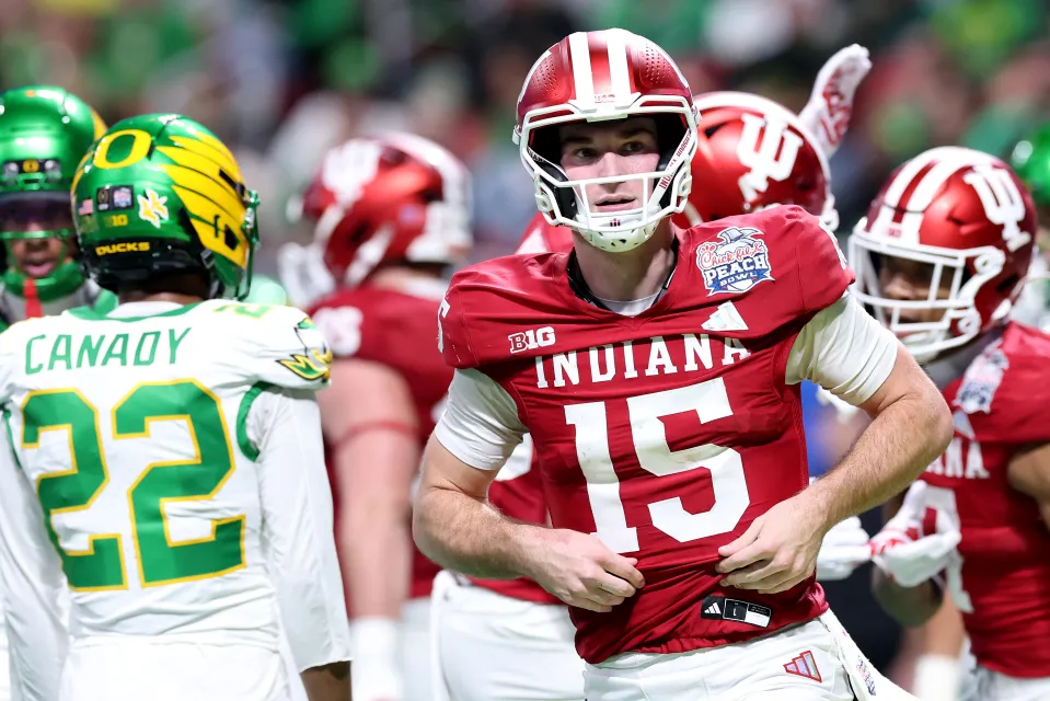 Fernando Mendoza #15 of the Indiana Hoosiers reacts after throwing a touchdown pass against the Oregon Ducks during the third quarter in the 2025 College Football Playoff Semifinal at the Chick-fil-A Peach Bowl at Mercedes-Benz Stadium