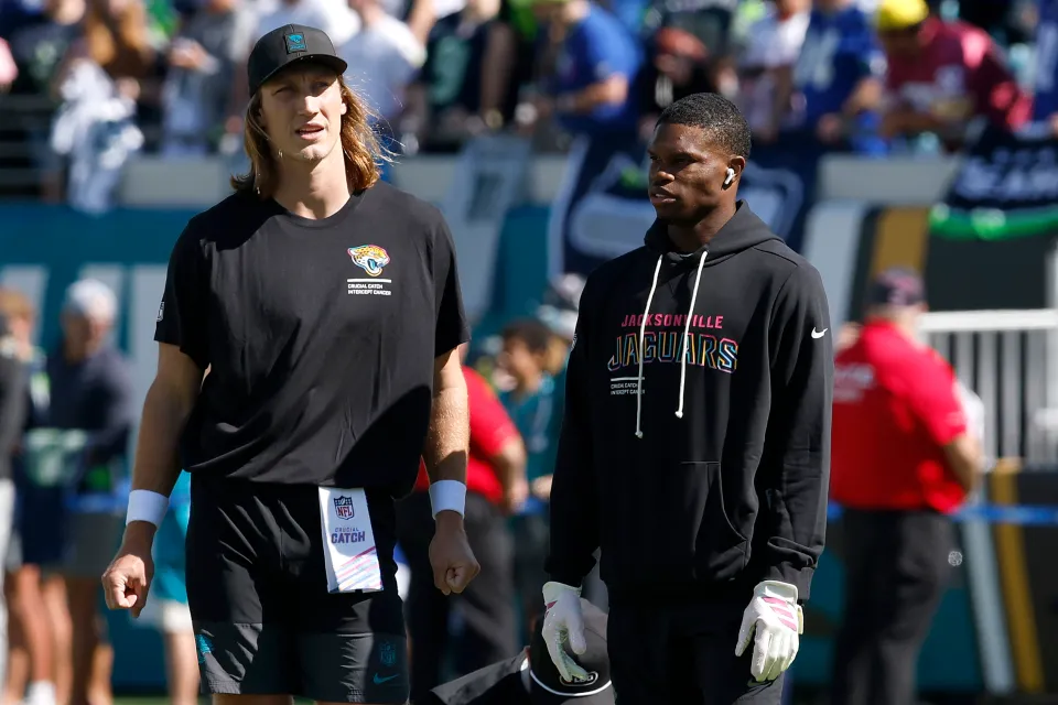 Trevor Lawrence #16 and Travis Hunter #12 of the Jacksonville Jaguars warm up prior to the game against the Seattle Seahawks at EverBank Stadium on October 12, 2025 in Jacksonville, Florida.